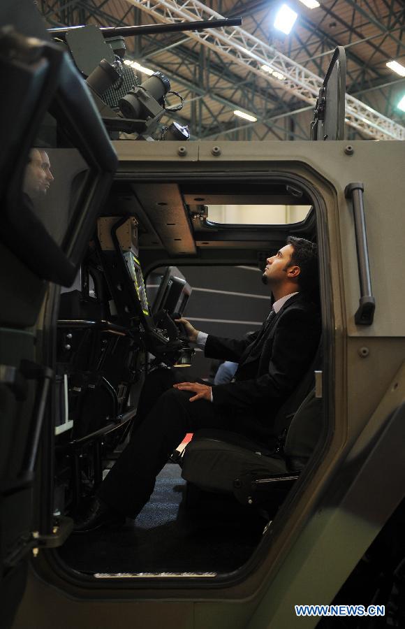 A guest sitting inside an armored vehicle operates the instrument in Istanbul, Turkey, May 7, 2013. The 11th International Defence Industry Fair was opened on Tuesday, with 781 companies from 82 countries and regions attending the four-day fair. (Xinhua/Lu Zhe)