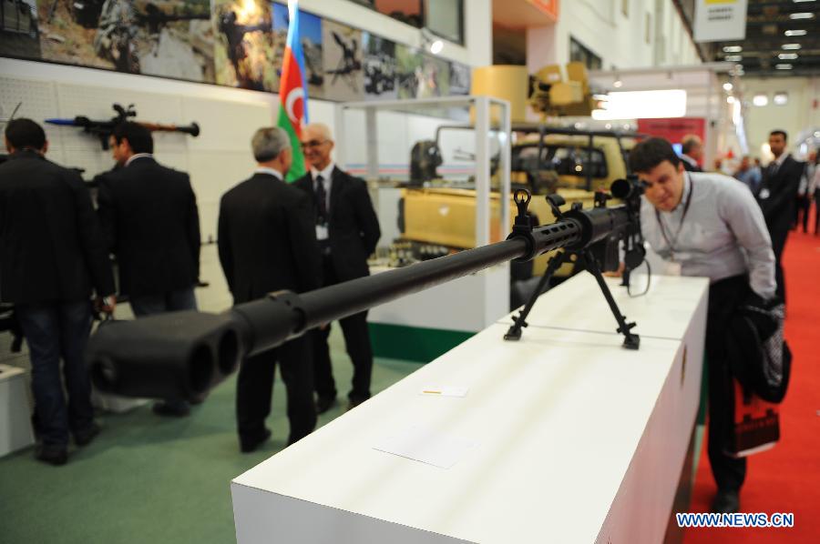 People visit a weapons booth of the Republic of Azerbaijan in Istanbul, Turkey, May 7, 2013. The 11th International Defence Industry Fair was opened on Tuesday, with 781 companies from 82 countries and regions attending the four-day fair. (Xinhua/Lu Zhe)