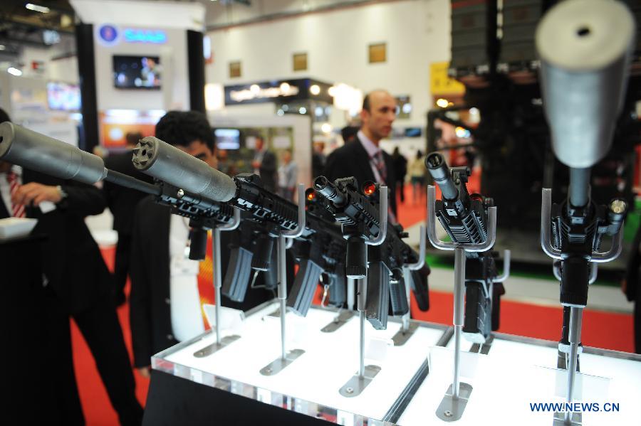 People visit a booth of a Switzerland-Germany firearms company in Istanbul, Turkey, May 7, 2013. The 11th International Defence Industry Fair was opened on Tuesday, with 781 companies from 82 countries and regions attending the four-day fair. (Xinhua/Lu Zhe)