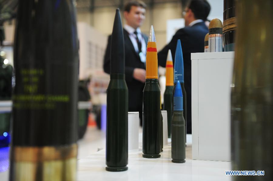 Guests talk with each other in front of an ammunition booth in Istanbul, Turkey, May 7, 2013. The 11th International Defence Industry Fair was opened on Tuesday, with 781 companies from 82 countries and regions attending the four-day fair. (Xinhua/Lu Zhe)