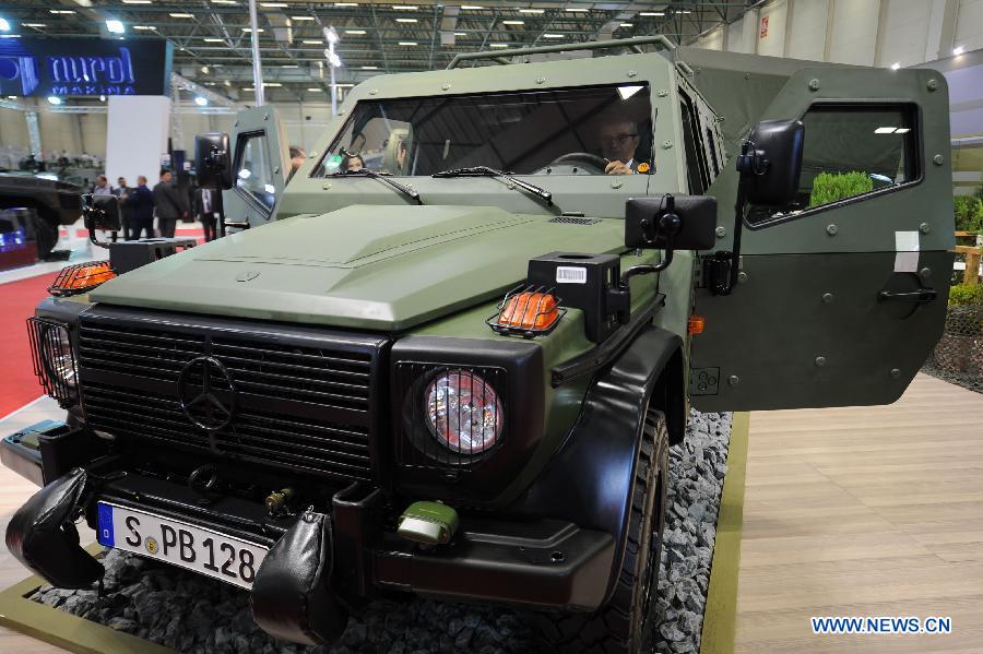 A visitor experience an armored vehicle made by Mercedes-Benz in Istanbul, Turkey, May 7, 2013. The 11th International Defence Industry Fair was opened on Tuesday, with 781 companies from 82 countries and regions attending the four-day fair. (Xinhua/Lu Zhe)