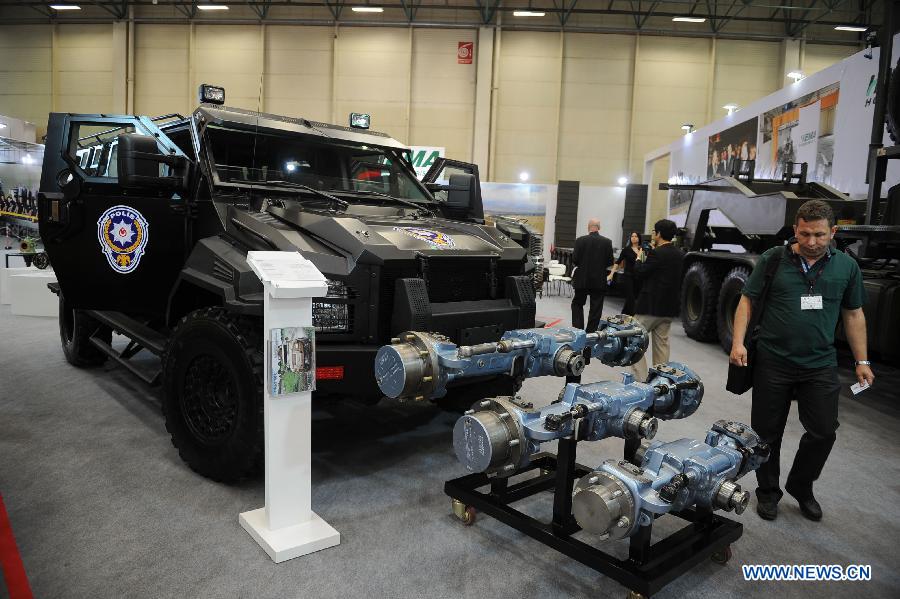 An audience passes by a police armored vehicles produced by a Turkish company in Istanbul, Turkey, May 7, 2013. The 11th International Defence Industry Fair was opened on Tuesday, with 781 companies from 82 countries and regions attending the four-day fair. (Xinhua/Lu Zhe)