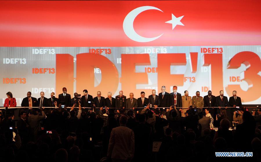 Guests cut the ribbon at the opening ceremony of the 11th International Defence Industry Fair in Istanbul, Turkey, May 7, 2013. The 11th International Defence Industry Fair was opened on Tuesday, with 781 companies from 82 countries and regions attending the four-day fair. (Xinhua/Lu Zhe)