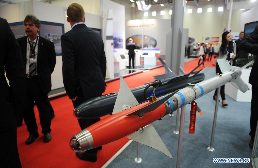 People visit a German company's missile booth in Istanbul, Turkey, May 7, 2013. The 11th International Defence Industry Fair was opened on Tuesday, with 781 companies from 82 countries and regions attending the four-day fair. (Xinhua/Lu Zhe)