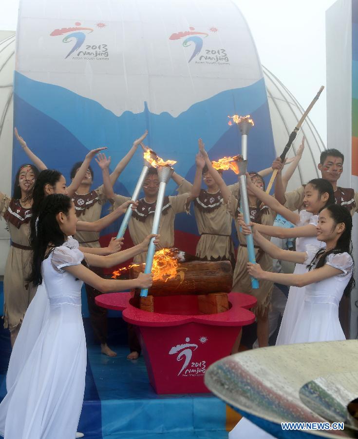 Four girls show the lighted torches during the 2nd Asian Youth Games Flame-Lighting ceremony in Nanjing, capital of east China's Jiangsu Province on May 8, 2013. The 2nd Asian Youth Games will be held in Nanjing on August 16, 2013. (Xinhua/Yang Lei)