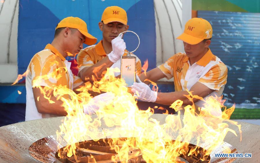 Flame guards light the lantern from the cauldron during the 2nd Asian Youth Games Flame-Lighting ceremony in Nanjing, capital of east China's Jiangsu Province on May 8, 2013. The 2nd Asian Youth Games will be held in Nanjing on August 16, 2013. (Xinhua/Yang Lei)
