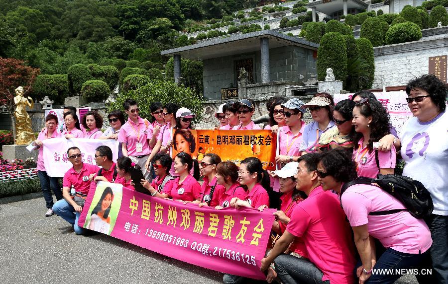 Fans pose for a photo in a cemetery in which Teresa Teng is tombed, in Xinbei City, southeast China's Taiwan, May 8, 2013. Fans from all over the world commemorated here on Wednesday the 18th anniversary of the death and 60th anniversary of the birth of Teresa Teng, the Taiwanese singer famous for her love songs. (Xinhua/Xie Xiudong) 