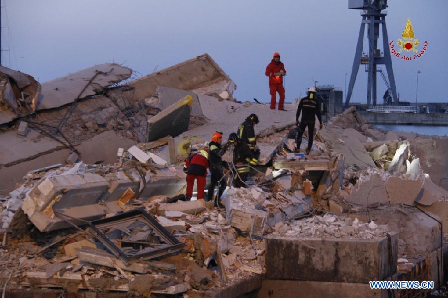 This photo released by Italian Vigili del Fuoco (Italian fire service) shows rescue workers inspecting the debris of the collapsed control tower at north Italy's Genoa port on May 8, 2013. The death toll of the Italian ship's accident in the northern Genoa port rose to seven late on Wednesday while more were injured or missing. Divers were still searching bodies trapped in the underwater rubble of a 50-meter-tall control tower that was demolished by the container ship Jolly Nero on Tuesday night. The ship, 239 meters long and with a gross tonnage of nearly 40,600 tonnes, suddenly crashed into the concrete and glass tower while maneuvering out the port in calm conditions. (Xinhua/Italian Vigili del Fuoco)