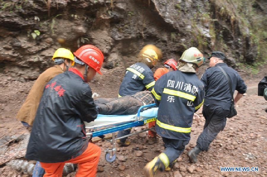 Rescuers transfer an injured person at the accident site after a landslide occurred in Lushan County of Ya'an City, southwest China's Sichuan Province, May 9, 2013. Two people were killed and another seven injured in the landslide on Thursday morning, when rocks caused by the landslide buried three vehicles with nine people aboard. The accident took place at the epicenter of a 7.0-Magnitude earthquake that struck on April 20. (Xinhua)