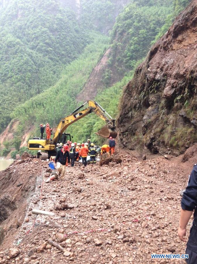 Rescuers work at the accident site after a landslide occurred in Lushan County of Ya'an City, southwest China's Sichuan Province, May 9, 2013. Two people were killed and another seven injured in the landslide on Thursday morning, when rocks caused by the landslide buried three vehicles with nine people aboard. The accident took place at the epicenter of a 7.0-Magnitude earthquake that struck on April 20. (Xinhua)