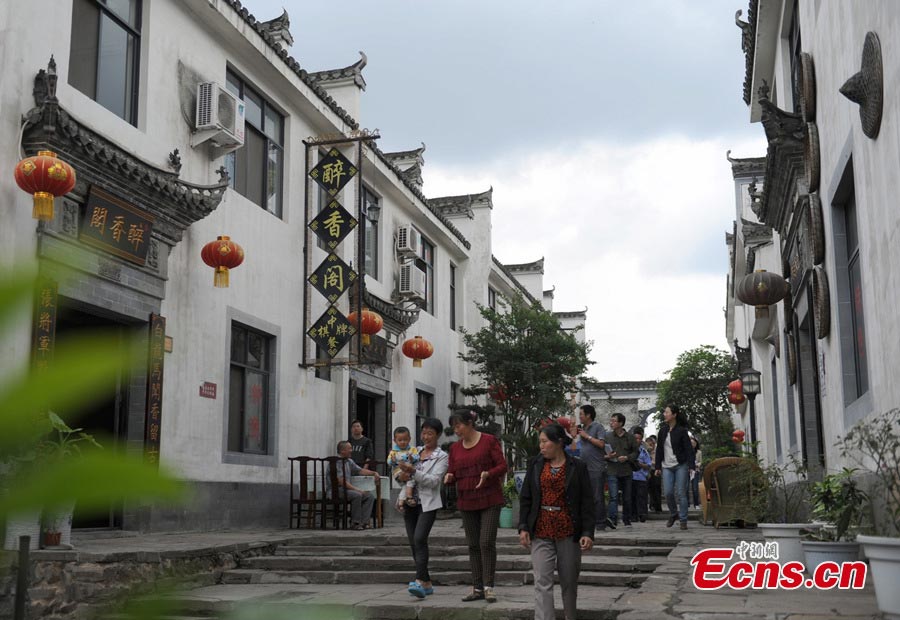 Visitors walk in a street in Baimaguan County, Luojiang, Sichuan Province. Damaged houses in Baimaguan have been restored five years after the Wenchuan earthquake, which transformed the county into a tourist attraction. In 2012, total revenue from tourism reached 186 million yuan. Baimaguan used to be a famous battlefield during the Three Kingdoms period (220 AD-280AD). (CNS/Liu Zhongjun)