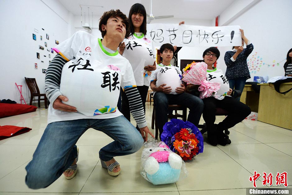 Male college students wear high heels and dress up as pregnant women to experience the hard life of a "mother-to-be" in a celebration of the upcoming Mother's Day in Yangzhou, east China's Jiangsu province, May 9, 2013. They hope this activity will express their best wishes to mothers and "mothers-to be". (Photo/CNS)
