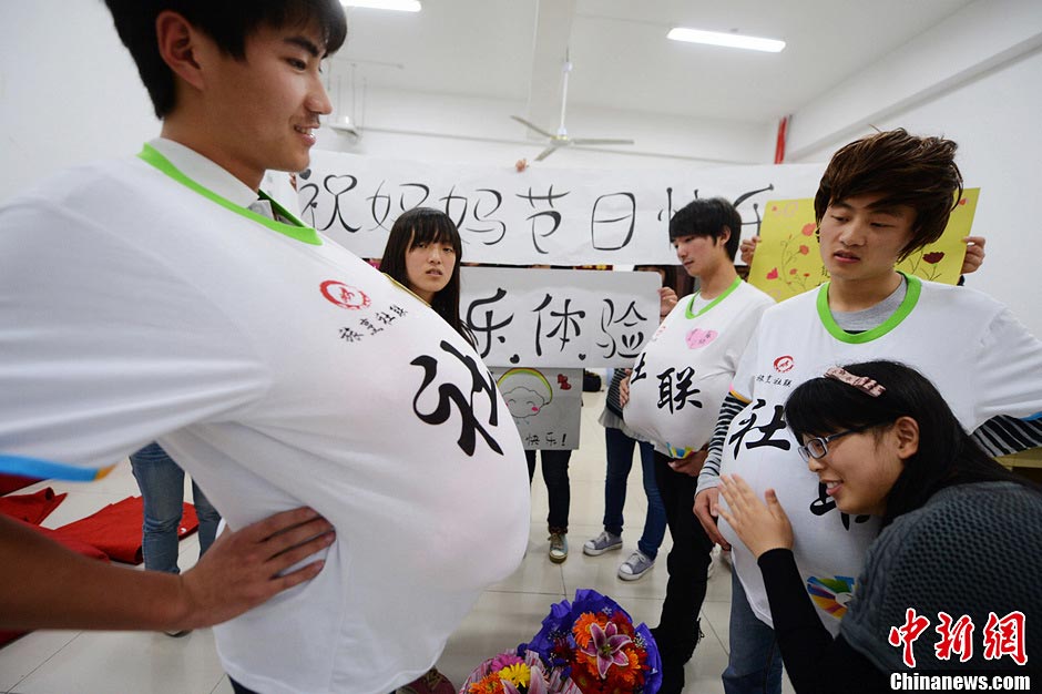 Male college students wear high heels and dress up as pregnant women to experience the hard life of a "mother-to-be" in a celebration of the upcoming Mother's Day in Yangzhou, east China's Jiangsu province, May 9, 2013. They hope this activity will express their best wishes to mothers and "mothers-to be". (Photo/CNS)