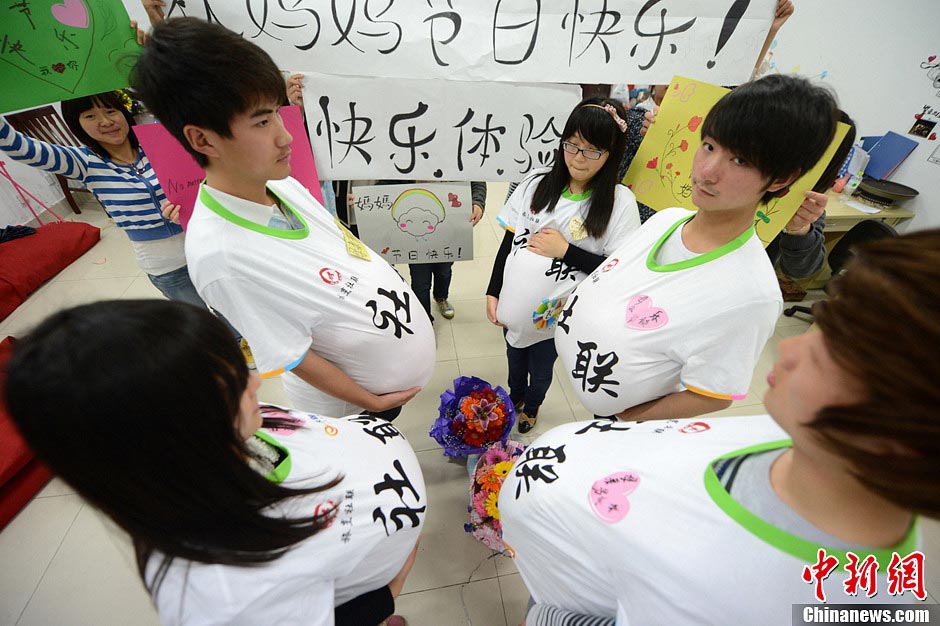Male college students wear high heels and dress up as pregnant women to experience the hard life of a "mother-to-be" in a celebration of the upcoming Mother's Day in Yangzhou, east China's Jiangsu province, May 9, 2013. They hope this activity will express their best wishes to mothers and "mothers-to be". (Photo/CNS)