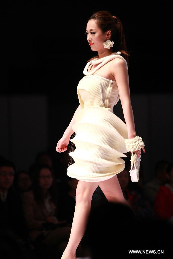 A model presents a fashion creation during the final of a knitting fashion design contest in Qingdao, a coastal city in east China's Shandong Province, May 7, 2013. (Xinhua/Liang Xiaopeng) 