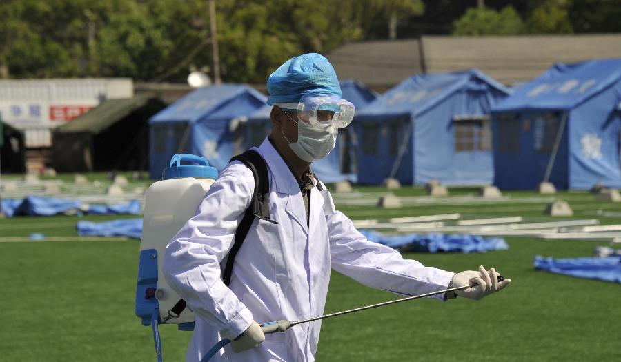 A health worker takes part in a disaster relief drill in Beijing, capital of China, May 10, 2013, two days ahead of the Disaster Prevention and Reduction Day. The Disaster Prevention and Reduction Day was set in 2009, after a devastating earthquake hit Sichuan and neighboring Gansu and Shaanxi provinces on May 12, 2008, leaving 87,000 people dead or missing. (Xinhua/Li Xin) 