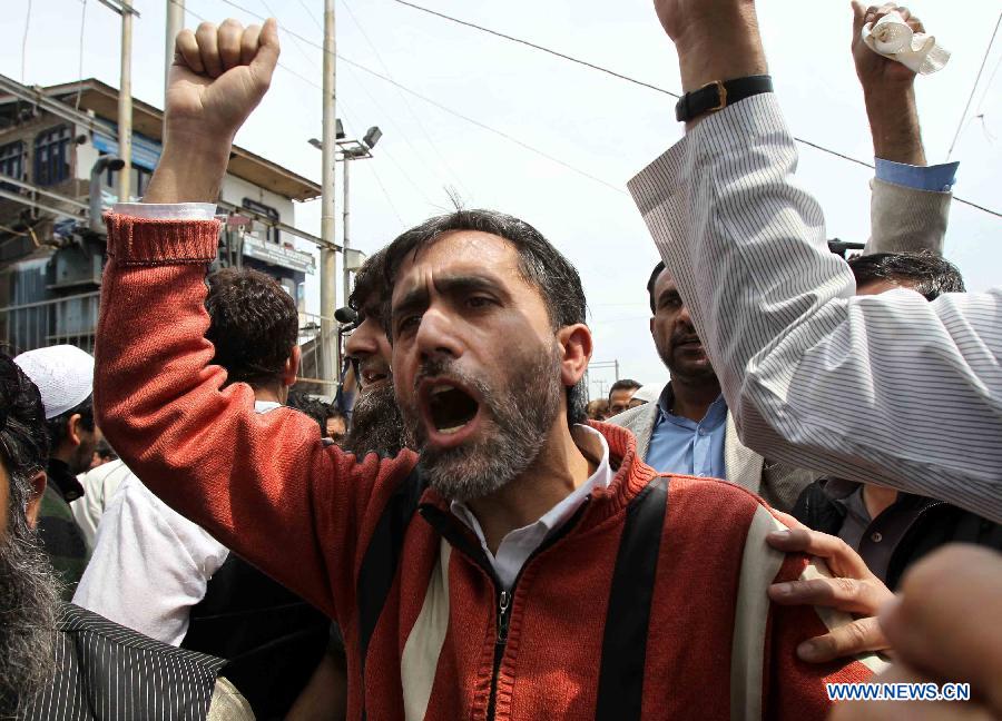 A Kashmiri Muslim shouts slogans after offering funeral prayers for the deceased Pakistani prisoner Sanaullah in Srinagar, summer capital of Indian-controlled Kashmir, May 10, 2013. Sanaullah suffered multiple head injuries after being attacked by another inmate and died due to multiple organ failure on Thursday. (Xinhua/Javed Dar) 
