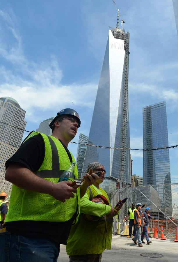 Workers are seen at the construction site of One World Trade Center (WTC) in New York, May 10, 2013. Workers have installed the final sections of the silver spire atop WTC on Friday, which brings the iconic New York City structure to its full, symbolic height of 1,776 feet (541 meters). (Xinhua/Wang Lei) 
