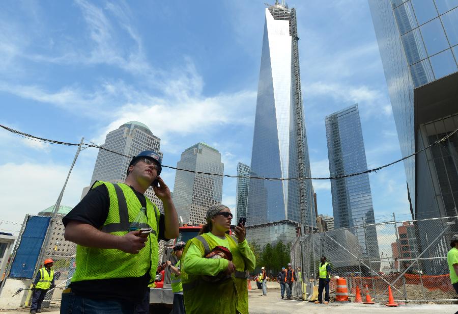Workers are seen at the construction site of One World Trade Center (WTC) in New York, May 10, 2013. Workers have installed the final sections of the silver spire atop WTC on Friday, which brings the iconic New York City structure to its full, symbolic height of 1,776 feet (541 meters). (Xinhua/Wang Lei) 