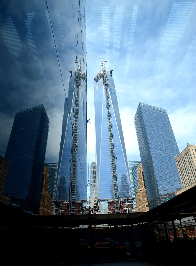 Photo taken on May 10, 2013 shows One World Trade Center (WTC) with new silver spire, in New York. Workers have installed the final sections of the silver spire atop WTC on Friday, which brings the iconic New York City structure to its full, symbolic height of 1,776 feet (541 meters). (Xinhua/Wang Lei) 