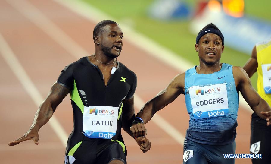 Justin Gatlin (L) of the United States reacts as he crosses the finish line during the men's 100m final at the IAAF Diamond League in Doha, capital of Qatar, May 10, 2013. Gatlin claimed the title of the event with 9.97 seconds. (Xinhua/Chen Shaojin) 