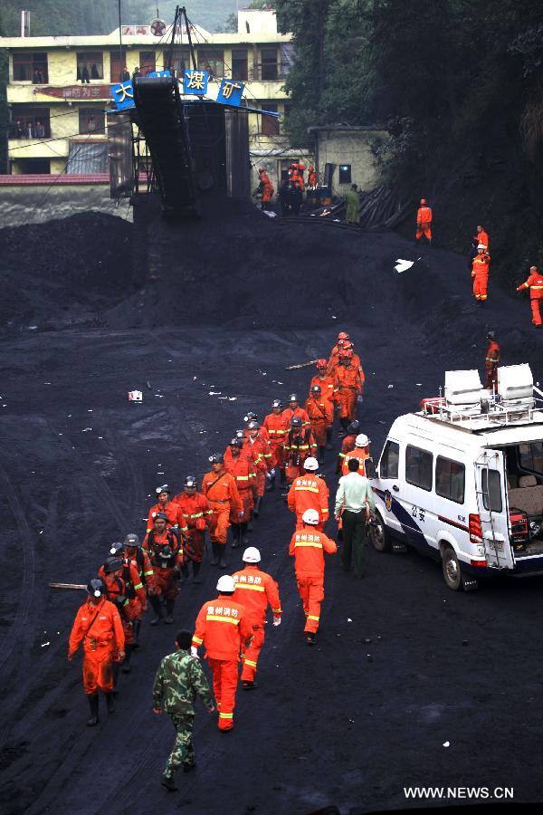 Rescuers work at the Dashan coal mine where a colliery gas explosion occurred in Pingba County, southwest China's Guizhou Province, May 11, 2013. Twelve people were killed and two others injured in the explosion on the evening of May 10. (Xinhua) 