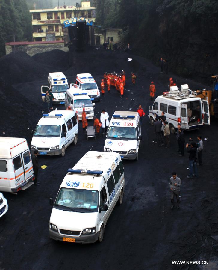 Ambulances park at the Dashan coal mine where a colliery gas explosion occurred in Pingba County, southwest China's Guizhou Province, May 11, 2013. Twelve people were killed and two others injured in the explosion on the evening of May 10. (Xinhua)  