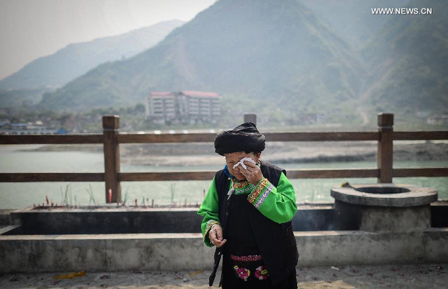 A 86-year-old woman from Qiang ethnic group mourns for deceased family members in the Wenchuan Earthquake in Beichuan County, southwest China's Sichuan Province, May 11, 2013. Many people returned to the Beichuan county to mourn for the dead as Sunday marks the fifth anniversary of the 8-magnitude quake that rocked Sichuan Province in 2008. (Xinhua/Jiang Hongjing)