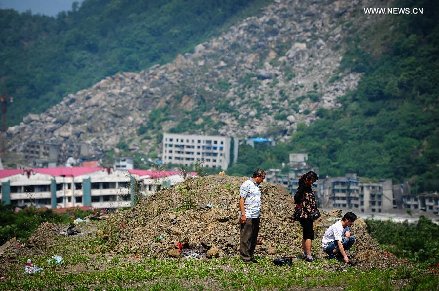People mourn for deceased family members in the Wenchuan Earthquake in Beichuan County, southwest China's Sichuan Province, May 11, 2013. Many people returned to the Beichuan county to mourn for the dead as Sunday marks the fifth anniversary of the 8-magnitude quake that rocked Sichuan Province in 2008. (Xinhua/Jiang Hongjing) 