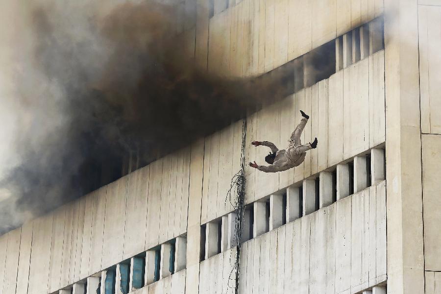 A man falls from a high floor of a burning building in central Lahore. Fire erupted on the seventh floor of the LDA plaza in Lahore and quickly spread to higher floors leaving many people trapped inside the building. At least three people fell from the high floors trying to avoid fire that engulfed the building, local media reports. (Xinhua/Reuters Photo)