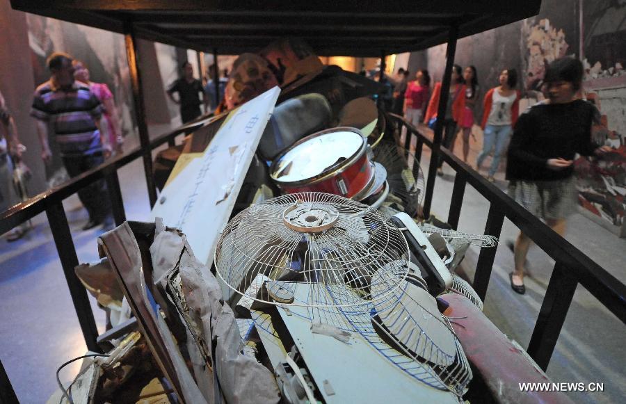 People visit the Wenchuan earthquake memorial hall in Beichuan, southwest China's Sichuan Province, May 12, 2013. Mourners gathered on Sunday in Beichuan, one of the worst hit regions in the Wenchuan Earthquake, to mark the fifth anniversary of the deadly earthquake on May 12, 2008 in which more than 80,000 people were killed or missing. (Xinhua/Xue Yubin)