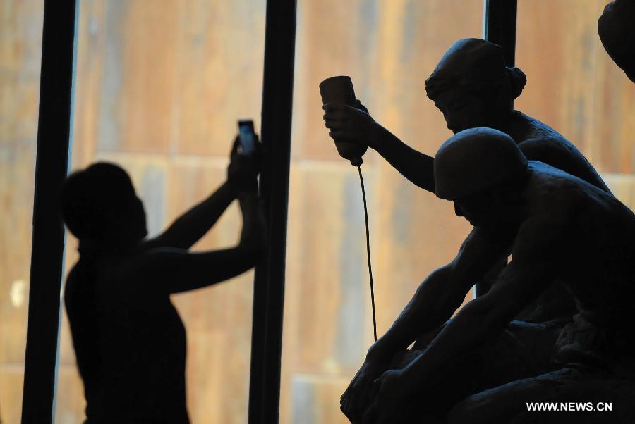 A visitor takes pictures at the Wenchuan earthquake memorial hall in Beichuan, southwest China's Sichuan Province, May 12, 2013. Mourners gathered on Sunday in Beichuan, one of the worst hit regions in the Wenchuan Earthquake, to mark the fifth anniversary of the deadly earthquake on May 12, 2008 in which more than 80,000 people were killed or missing. (Xinhua/Xue Yubin)