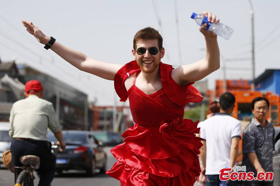 Hundreds of women – and especially men in their red dresses participate in the Red Dress Run in Beijing, May 12, 2013. (CNS/Fu Tian)