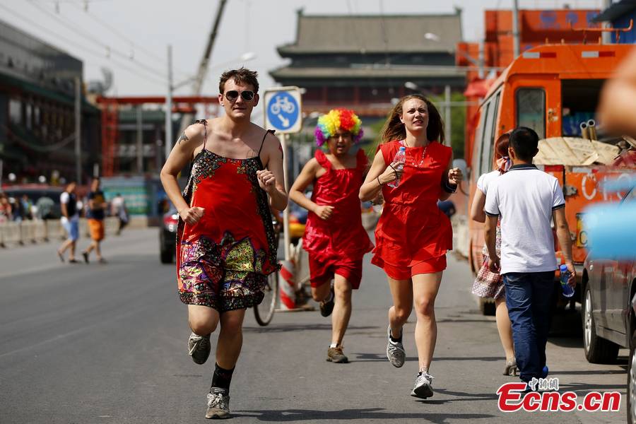 Hundreds of women – and especially men in their red dresses participate in the Red Dress Run in Beijing, May 12, 2013. (CNS/Fu Tian)