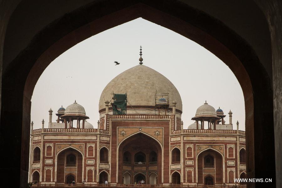 Photo taken on May 12, 2013 shows Humayun's Tomb in New Delhi, capital of India. Humayun's Tomb, located in east New Delhi, was built in 1569 to 1570 by Humayun's widow. As a precursor to the Taj Mahal, it stands on a platform of 12,000 square meters and reaches a height of 47 meters. The earliest example of the Persian influence in Indian architecture, the tomb itself is in the center of a large garden, surrounded by 12 hectares of gardens with pools joined by channels. The tomb brought Persian style to Delhi, but the two-tone combination of red sandstone and white marble is local, which shows the merging of different cultures. Humayun's Tomb was inscribed on the World Heritage List by the United Nations Educational, Scientific and Cultural Organization in 1993. (Xinhua/Zheng Huansong)