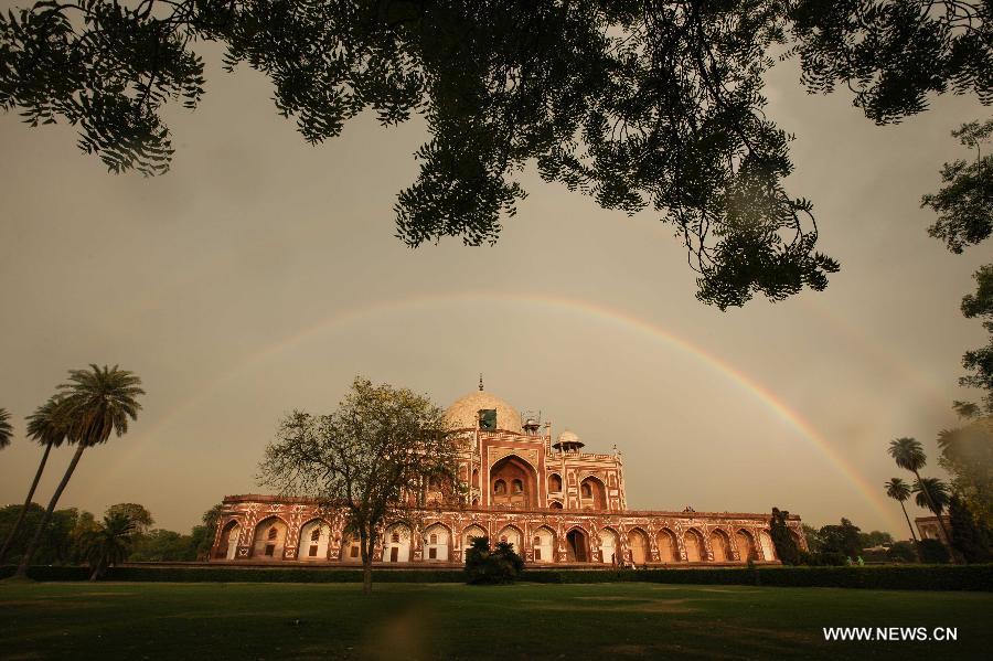 Two rainbows are seen above Humayun's Tomb in New Delhi, capital of India, May 12, 2013. Humayun's Tomb, located in east New Delhi, was built in 1569 to 1570 by Humayun's widow. As a precursor to the Taj Mahal, it stands on a platform of 12,000 square meters and reaches a height of 47 meters. The earliest example of the Persian influence in Indian architecture, the tomb itself is in the center of a large garden, surrounded by 12 hectares of gardens with pools joined by channels. The tomb brought Persian style to Delhi, but the two-tone combination of red sandstone and white marble is local, which shows the merging of different cultures. Humayun's Tomb was inscribed on the World Heritage List by the United Nations Educational, Scientific and Cultural Organization in 1993. (Xinhua/Zheng Huansong)