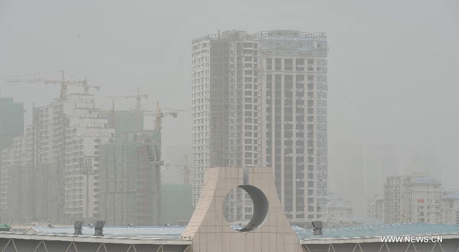 The city landscape is seen enveloped in dust in Yinchuan, capital of northwest China's Ningxia Hui Autonomous Region, May 13, 2013. Floating dust hit Yinchuan on Monday. (Xinhua/Peng Zhaozhi) 