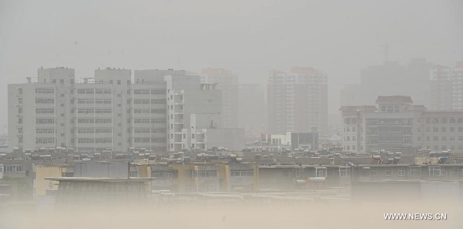 The city landscape is seen enveloped in dust in Yinchuan, capital of northwest China's Ningxia Hui Autonomous Region, May 13, 2013. Floating dust hit Yinchuan on Monday. (Xinhua/Peng Zhaozhi) 