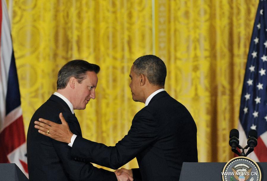 U.S. President Barack Obama (R) shakes hand with British Prime Minister David Cameron as they leave a joint press conference following their talks at the White House in Washington D.C. on May 13, 2013. (Xinhua/Fang Zhe) 