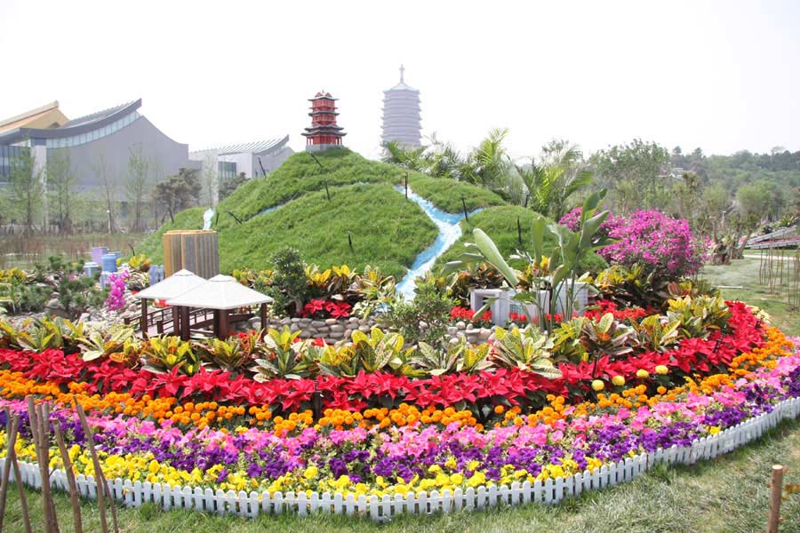 A miniature landscape featuring a hill dotted with flowers, pavilions and a tower model on its top in the Ninth China (Beijing) International Garden Expo in western Beijing. The expo covers an area of 513 hectares, including 267-hecare public exhibition area and 246-hectare Garden Expo Lake. The event will officially kick off on May 18, 2013 and last for six months. (CRIENGLISH.com/Luo Dan)