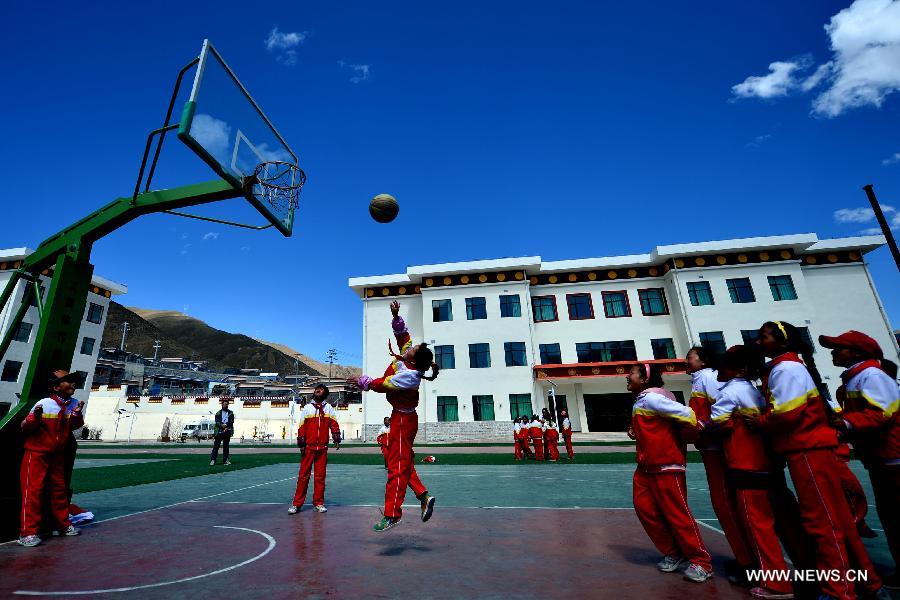 Orphan students take physical exercise class at the Bayi Orphan School in Yushu Tibet Autonomous Prefecture in northwest China's Qinghai Province, May 13, 2013. The school is now a home of 323 orphan students who are instructed and cared by 57 teachers. (Xinhua/Wang Bo)