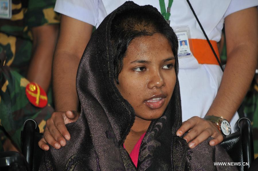 Reshma, a young female garment worker, meets with the media at a hospital in Savar on the outskirts of Dhaka, Bangladesh, May 13, 2013. Sixteen days after Bangladesh's worst-ever industrial tragedy, rescuers found Reshma who is clinging to life beneath the sandwiched floors of the collapsed eight-storey building. (Xinhua/Shariful Islam)