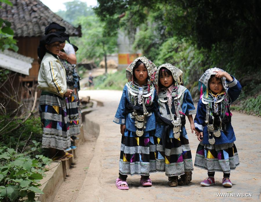 Little girls of the Yi ethnic group attend their traditional "Qiaocai Festival" at Chengzhai Village in Malipo County of Wenshan Zhuang-Miao Autonomous Prefecture, southwest China's Yunnan Province, May 14, 2013. The Bailuo people living in Wenshan is a subline of the Yi ethnic group. The Qiaocai Festival, one of the Bailuo people's most important festival, was celebrated at Chengzhai Village on Tuesday. During the festival, the Bailuo people dress in their folk costumes and perform their traditional dancing. (Xinhua/Qin Lang) 