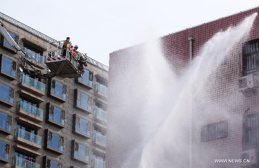 Rescuers take part in an earthquake drill at the Fendou Elementary School in Beijing, capital of China, May 15, 2013. (Xinhua/Li Wen) 