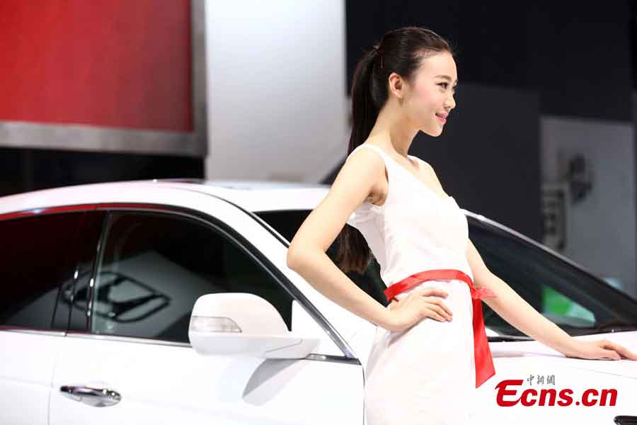 A model presents a car at the 2013 Qingdao International Auto Show, which kicks off in Qingdao, a coastal city in East China's Shandong Province, May 14, 2013. (CNS/Xu Chongde)
