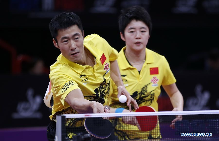 Wang Liqin (L) and Rao Jingwen of China compete during round of 64 of mixed doubles match against Robert Floras and Monika Pietkiewicz of Poland at Palais omnisport de Paris Bercy in Paris, France, on May 15, 2013. Wang Liqin and Rao Jingwen won 4-1. (Xinhua/Wang Lili)