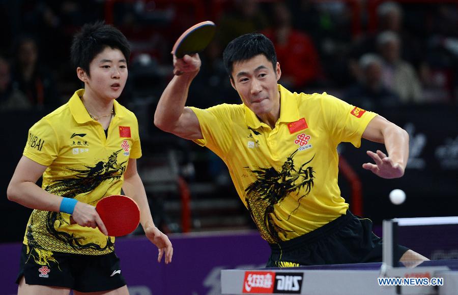 Wang Liqin (R) and Rao Jingwen of China compete during round of 64 of mixed doubles match against Robert Floras and Monika Pietkiewicz of Poland at Palais omnisport de Paris Bercy in Paris, France, on May 15, 2013. Wang Liqin and Rao Jingwen won 4-1. (Xinhua/Tao Xiyi)