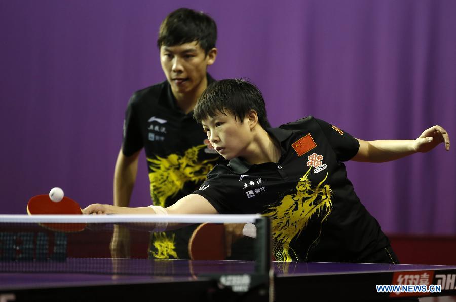 Chen Qi and Hu limei (R) of China compete during round of 64 of mixed doubles match against Steffen Mengel and Sabine Winter of Germany at Palais omnisport de Paris Bercy in Paris, France, on May 15, 2013. Chen Qi and Hu Limei won 4-3. (Xinhua/Wang Lili)