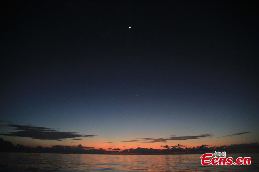 The sky turns red at sunset over waters off the Nansha Islands in the South China Sea, May 14, 2013. A fleet of 32 Chinese fishing boats arrived in Nansha Islands on Tuesday after a 7-day voyage. (CNS/Wang Xiaobin)