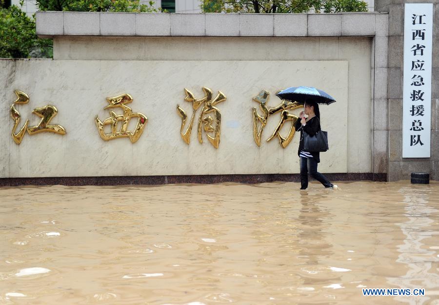 Photo taken on May 14, 2013 shows the flooded gate of the Firefighting Department of Jiangxi Province on Fusheng Road in Nanchang City, capital of east China's Jiangxi Province. A heavy rainfall hit Jiangxi Province on May 14. The average rainfall of the province reached 46.4 millimeters, with that of Nanchang climbing to the highest of 71 millimeters May 15. (Xinhua/Yuan Zheng)